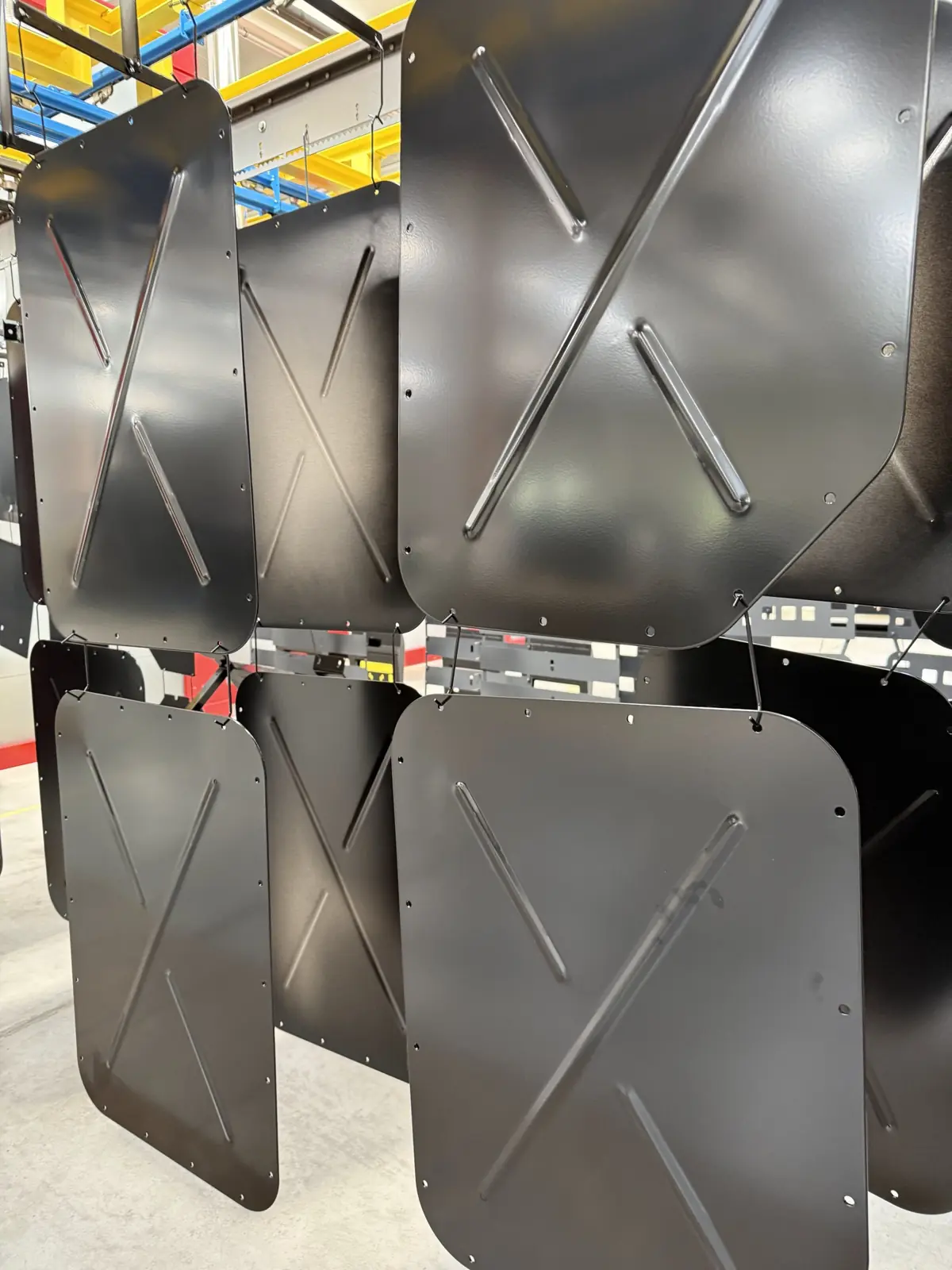 Panels with formed stiffening ribs, powder coated black