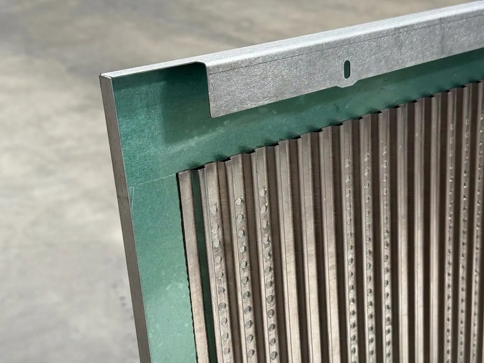 Two-sheet sandwich panel: a perforated corrugated sheet closed inside a formed frame